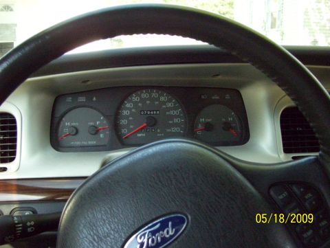 2003 Ford Crown Victoria - The interior dashboard shows the odometer reading 079468 and the Ford logo on the steering wheel.