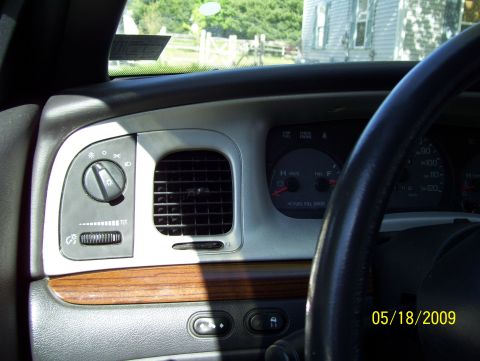2003 Ford Crown Victoria - Dashboard view of a 2003 Ford Crown Victoria, including the steering wheel and instrument cluster.