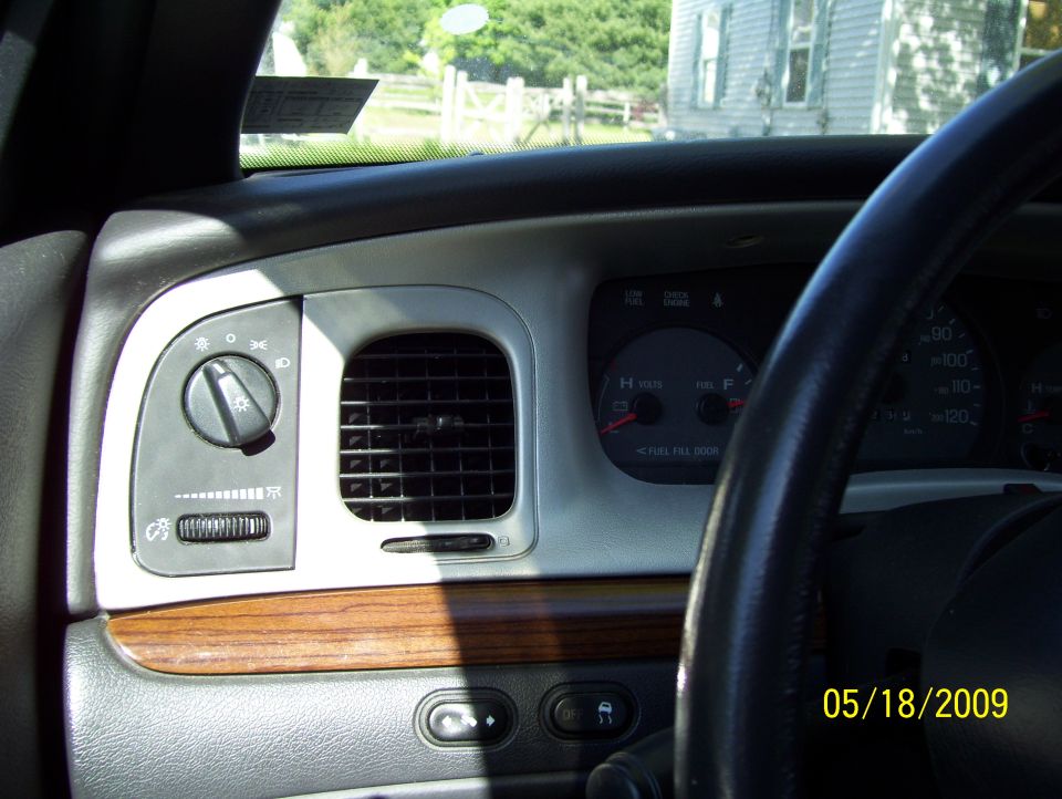 2003 Ford Crown Victoria interior showing dashboard, steering wheel, and air vent