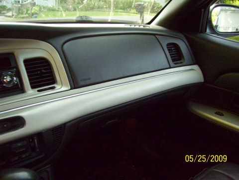 2003 Ford Crown Victoria - Interior view of a car's dashboard, showing the passenger side with air vents and trim details.