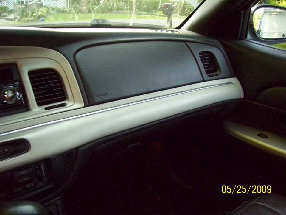 Car interior dashboard with beige trim, air vents, and an airbag label