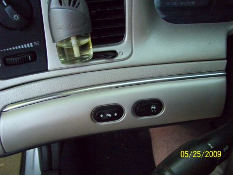 2003 Ford Crown Victoria - Dashboard controls including climate settings and a traction control button are visible.