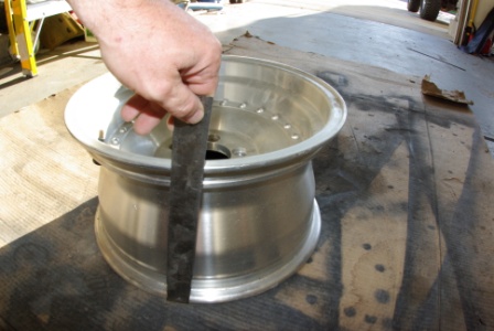 1995 Ford Bronco - Measuring an aluminum wheel with a ruler.