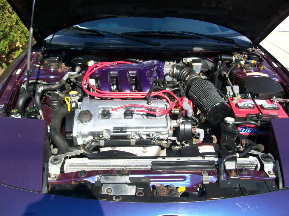 engine bay with purple intake manifold and red spark plug wires