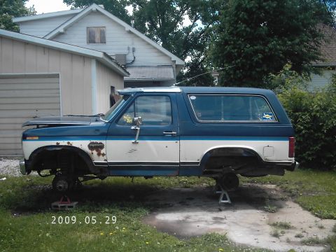 1986 Ford Bronco - This 1986 Ford Bronco is shown on jack stands with its wheels removed, undergoing maintenance.