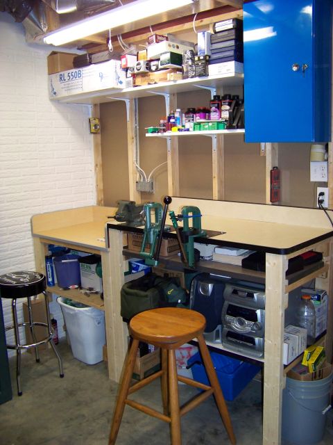 1995 Mercury Grand Marquis - A cluttered workbench area with tools, storage, and a blue cabinet is shown in this workshop scene.