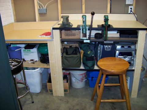 1995 Mercury Grand Marquis - A workbench is set up with reloading equipment and various items stored underneath.