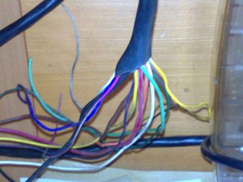 1991 Ford Crown Victoria - Close-up of a messy bundle of electrical wires with various colors, some stripped.