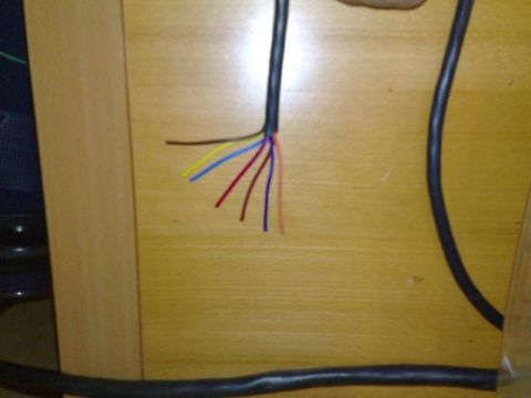 1991 Ford Crown Victoria - The ends of a bundle of wires are exposed, showing multiple colored strands against a wooden background.