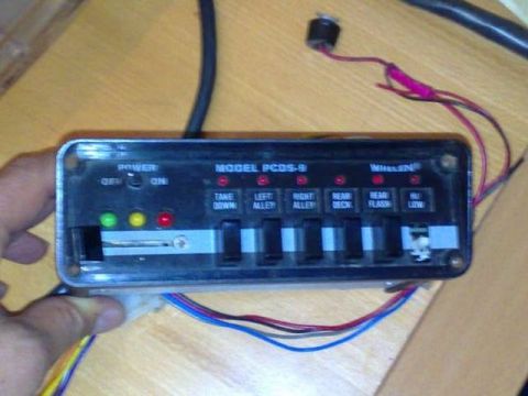 1991 Ford Crown Victoria - Whelen Model PCDS-9 control box for police lights, held by a hand.