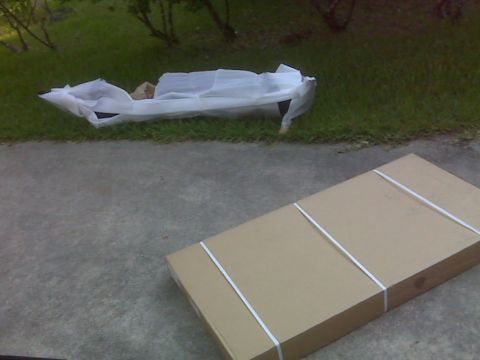 2008 Jeep Wrangler - A Smittybilt SRC rear bumper is visible, partially unwrapped and lying on the grass.