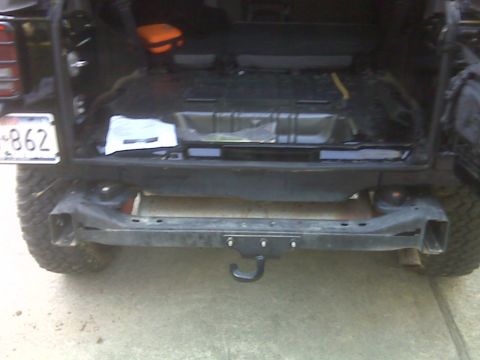 2008 Jeep Wrangler - Aftermarket rear bumper and trailer hitch on a 2007 Jeep Wrangler, showing the underside and spare tire well.