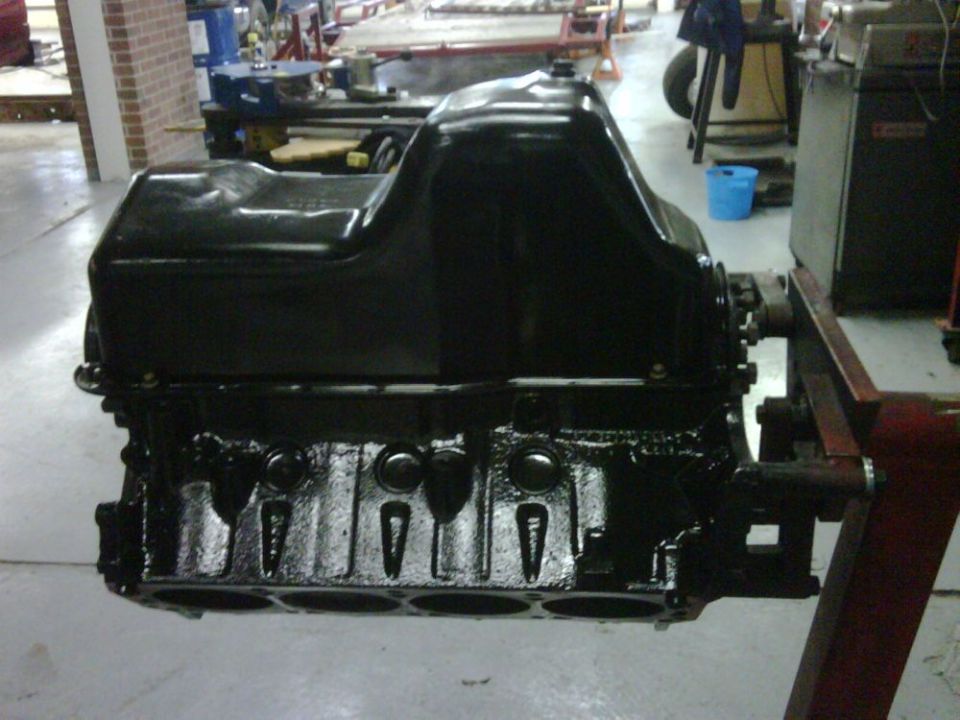Black engine block with oil pan mounted on an engine stand
