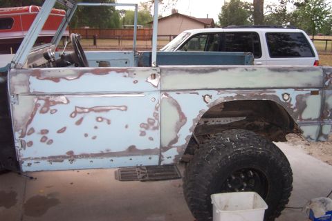 1976 Ford Bronco - This Ford Bronco is undergoing bodywork, with primer and patches visible on its side panels.
