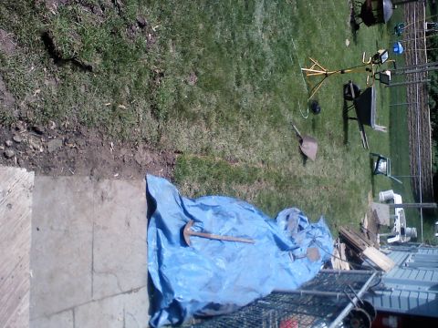 1979 Ford Bronco - Yard work in progress with various tools and equipment scattered around the lawn.