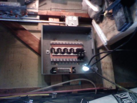 1979 Ford Bronco - An electrical panel is shown mounted on a wooden wall, with visible wiring and breakers.