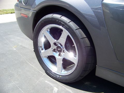 1993 Ford Bronco - Close-up of a car's rear fender and wheel, showing the SVT logo on the center cap.