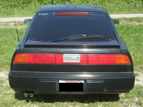 1989 Nissan 300ZX - Rear view of a black Nissan 300ZX, identifiable by its distinctive taillight design and body shape.