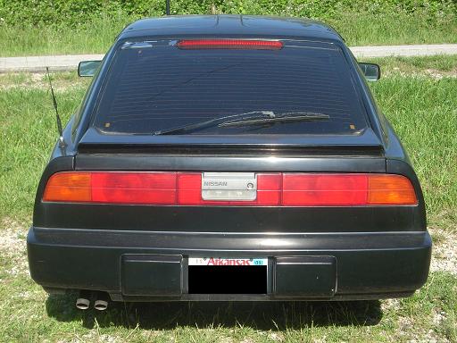 Black Nissan 300ZX rear view, showing horizontal taillights and a license plate