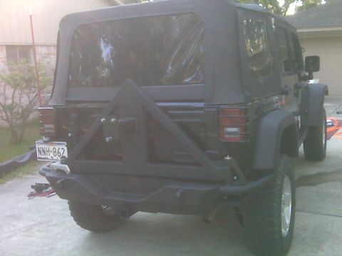 2008 Jeep Wrangler - Aftermarket rear bumper and spare tire carrier installed on a Jeep Wrangler.