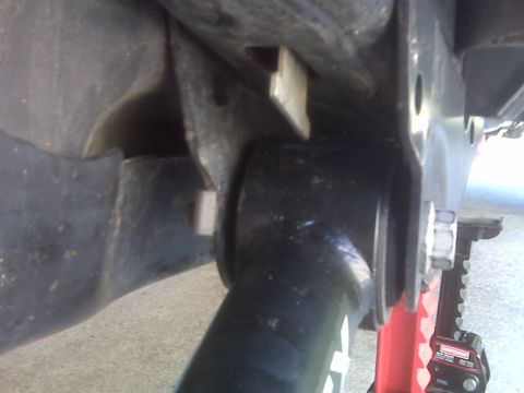 2008 Jeep Wrangler - Undercarriage view of vehicle suspension parts, with a red jack stand visible.