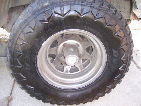 1991 Ford Bronco - Close-up view of a vehicle's tire and wheel assembly.