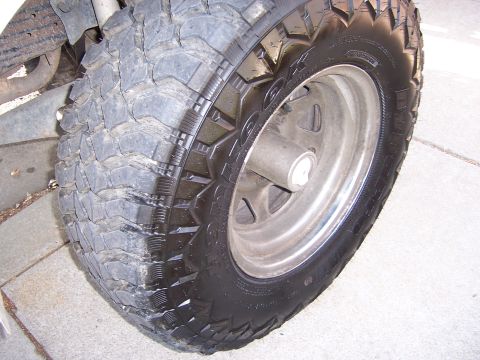 1991 Ford Bronco - A close-up view of a tire and wheel assembly, likely from an off-road vehicle.