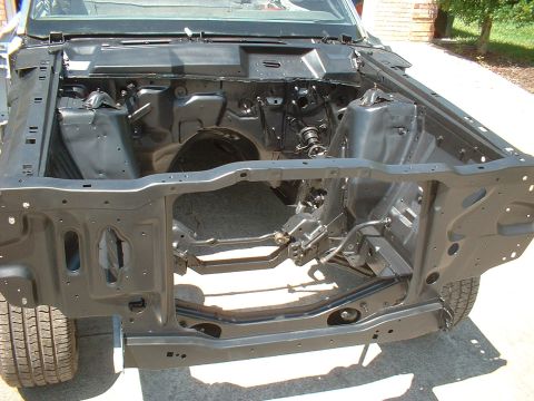 1970 Ford Torino - The bare frame of a car's engine bay is shown, with a tire visible on the left.