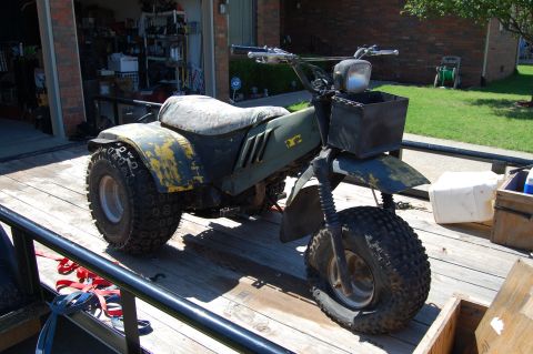 1985 Ford Ranger - Three-wheeled ATV with a flat front tire sits on a wooden trailer.