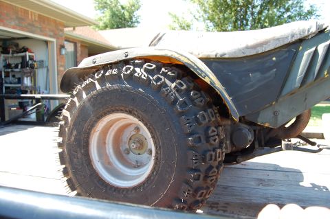 1985 Ford Ranger - A three-wheeled ATV is parked outdoors, showing its rear tire and part of its body.