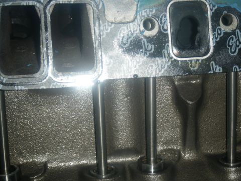 1979 Chevrolet Camaro - Close-up of an engine intake manifold and gasket, showing ports and pushrods.