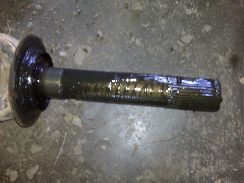 1992 Ford F-350 - A close-up view of a driveshaft component, showing its splined end and a protective rubber boot.