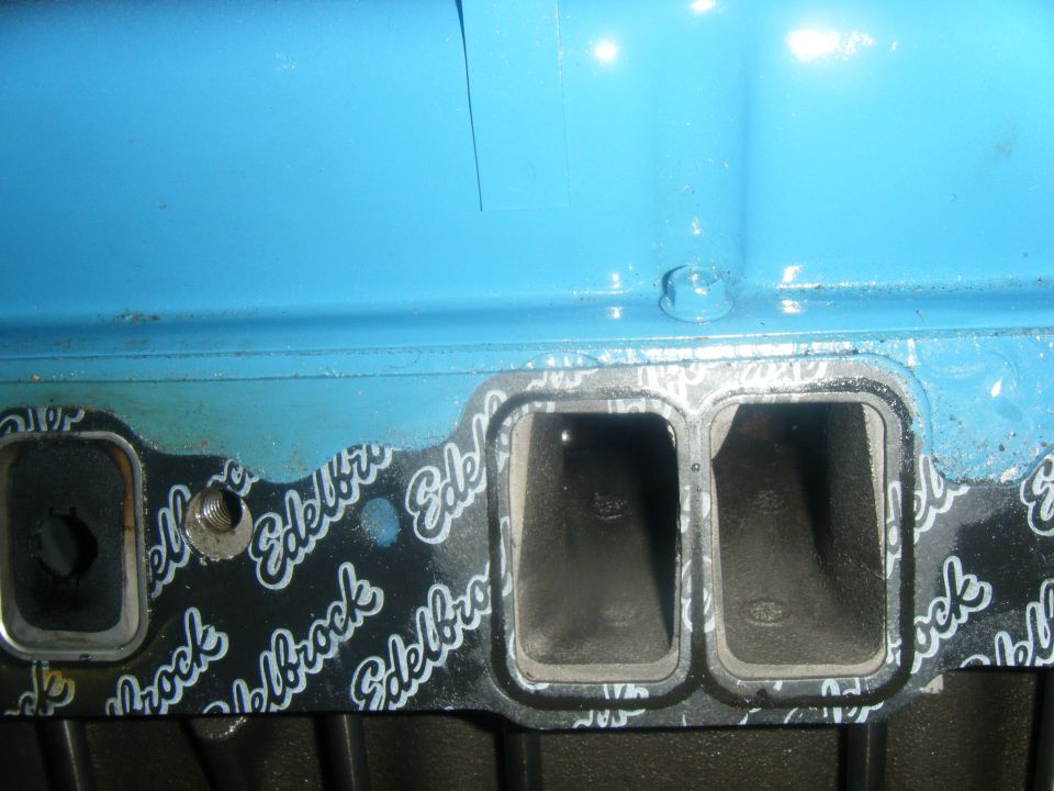 Close-up of Edelbrock intake manifold gasket on a blue engine component