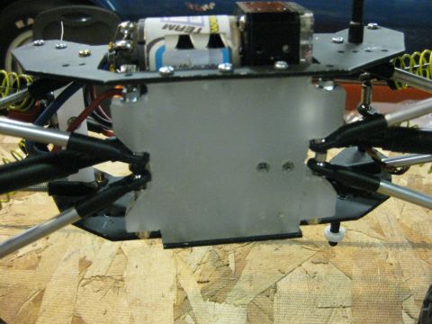 2010 Ford Pickup - Close-up view of the chassis and suspension of a remote control car, showing batteries and wiring.