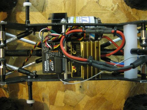 2010 Ford Pickup - Close-up of an RC car's internal electronics and chassis components.