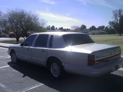 1992 Lincoln Town Car - This 1992 Lincoln Town Car is seen from the rear three-quarter angle under a bright, partly cloudy sky.