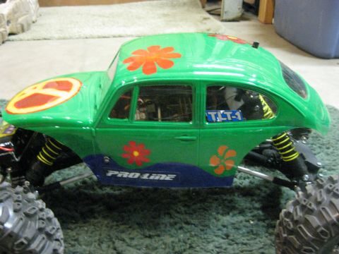 2010 Ford Pickup - This custom-painted Volkswagen Beetle body features a peace sign, flowers, and "PRO-LINE" branding.
