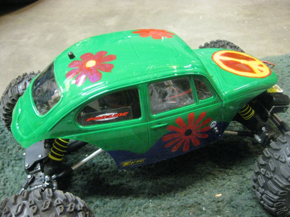 Green RC car body with red flowers and a peace sign, Pro-Line sticker visible