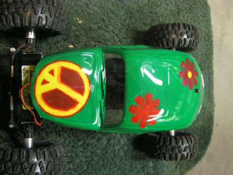 2010 Ford Pickup - This remote-controlled car is painted green and decorated with a peace symbol and floral designs.