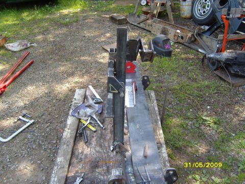 1989 Ford Bronco - Metal fabrication equipment and tools are laid out on a workbench in an outdoor setting.