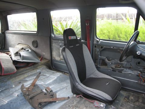 1986 Ford Bronco - Interior view of a 1986 Ford Bronco, a racing seat and stripped-down interior.