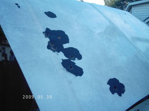 1986 Ford Bronco - Hood damaged with multiple holes, possibly from gunfire. Date stamp visible.