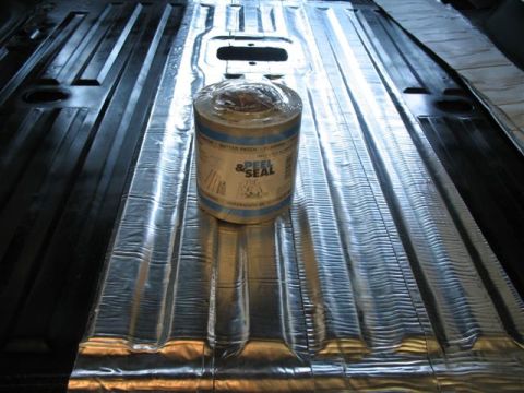1992 Ford Bronco - A roll of Peel & Seal self-adhesive flashing/gutter patch sits on a metal vehicle floor that has been lined with reflective silver adhesive…