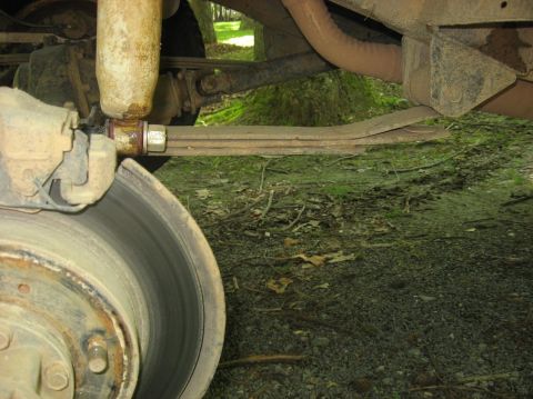 1987 Suzuki Samurai - Close-up view of the rear suspension components of a 1987 Suzuki Samurai, showing the leaf springs and shock absorber.
