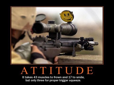 1988 Ford Bronco - A rifle with a smiley face target attached to the scope is aimed by a person wearing a balaclava.
