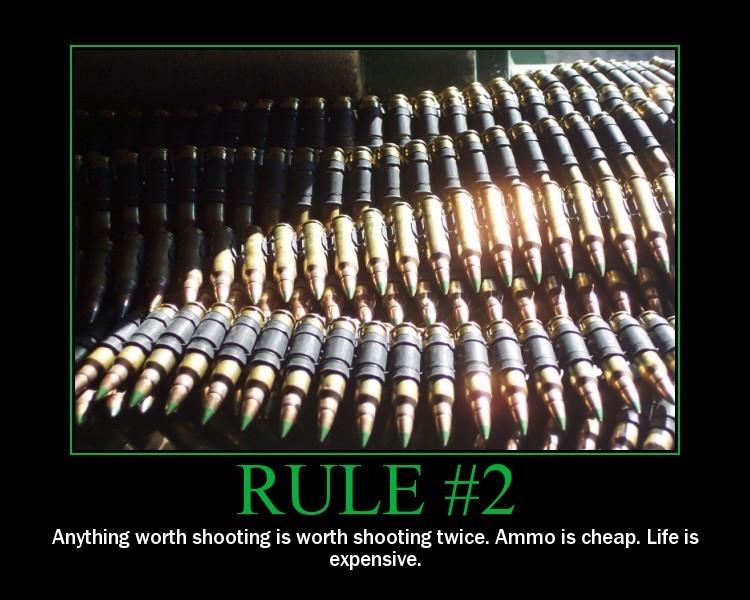 Belts of ammunition, some with green tips, arranged in rows. Text below reads 'RULE #2 Anything worth shooting is worth shooting twice. Ammo is cheap. Life is expensive.'