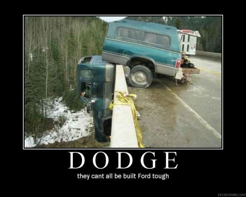 1988 Ford Bronco - A precarious situation unfolds as two trucks teeter on the edge of a bridge, with one's cab dangling precariously.