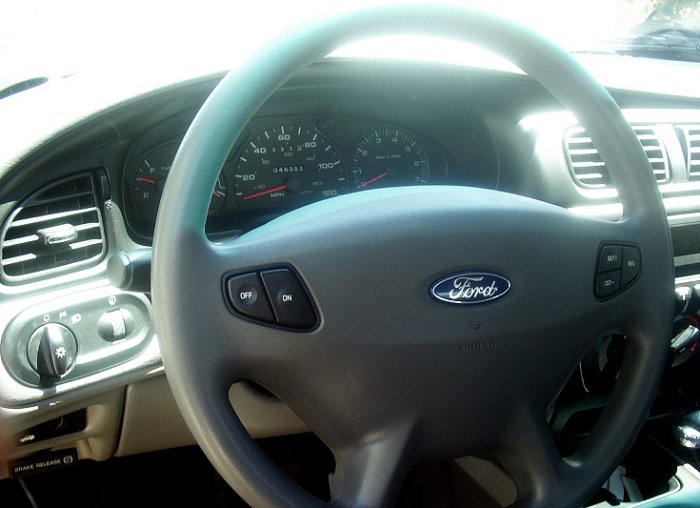 Interior view of a 2000 Ford Taurus showing the steering wheel and dashboard