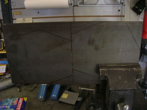 1996 Ford Bronco - A metal plate, marked with cut lines and held in a vise, sits on a workbench with tools and adhesives.
