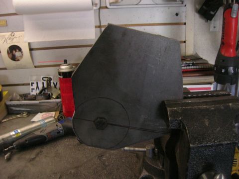 1996 Ford Bronco - A metal part, possibly for a vehicle suspension, is held in a vise for modification.